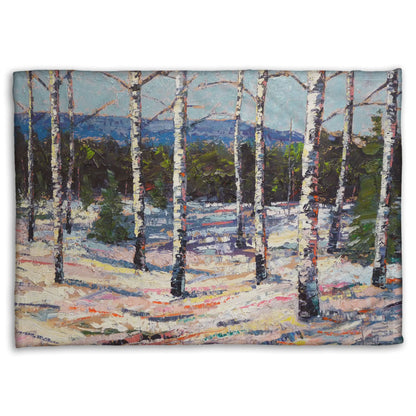 Coral fleece blanket printed with a painting of birch trees in a snowy landscape with mountains in the background.