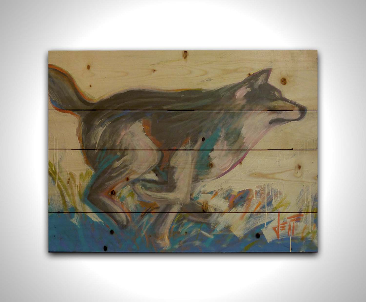 A painting of a running wolf created with dynamic brushstrokes and eye-catching colors, with reds and blues highlighting the edges. Printed on a wood pallet.