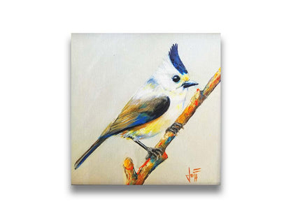 A painting of a titmouse bird with white, yellow, and gray feathers accented with blue perched on a stick, set against an off-white background. Printed on canvas.