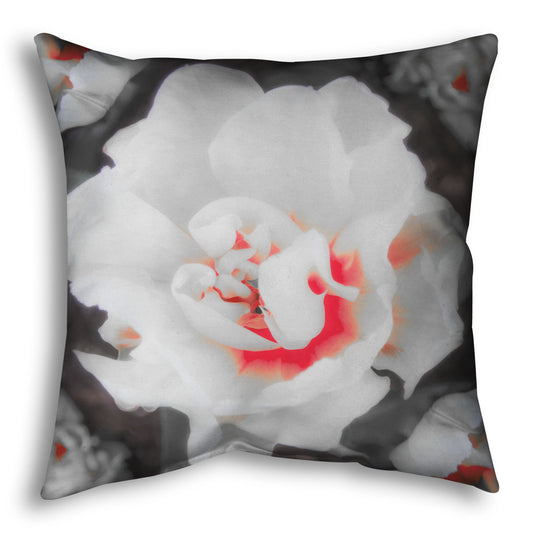 A throw pillow designed with a closeup photograph of a fancy tulip in grayscale, with one pop of pink and red in the center.