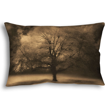 A throw pillow designed with an edited photo of a large, isolated tree in fall, colored in sepia tone.