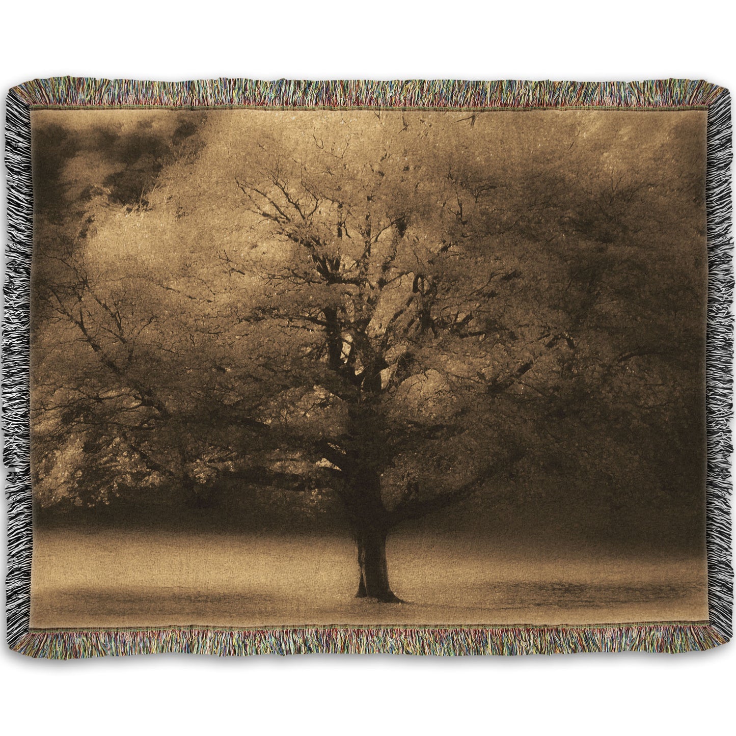 A woven throw blanket designed with an edited photo of a large, isolated tree in fall, colored in sepia tone.
