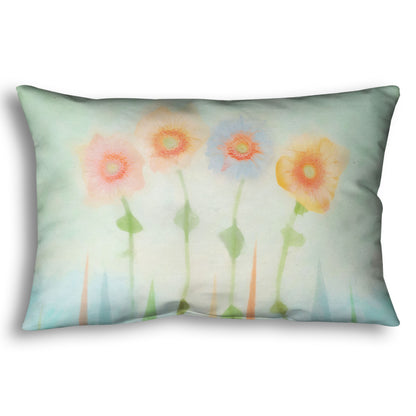 A throw pillow designed with an edited photo of flowers, the stems and background of trees illustrated to look like watercolor.