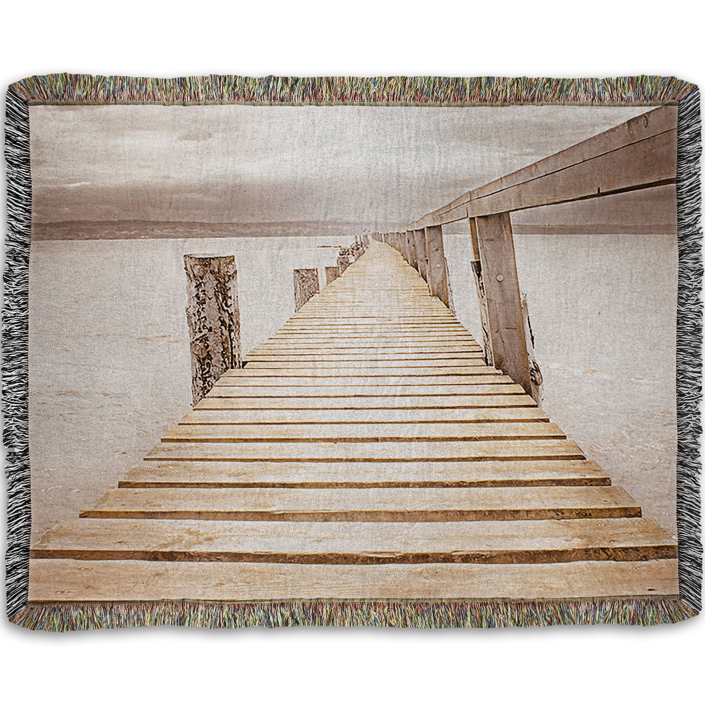 A woven throw blanket designed with a photo looking along a pier out into the water, edited in a sepia tone.