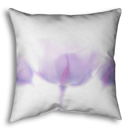 A throw pillow designed with a  photo of three pale purple roses against a pure white background, enveloped in a gentle white glow.