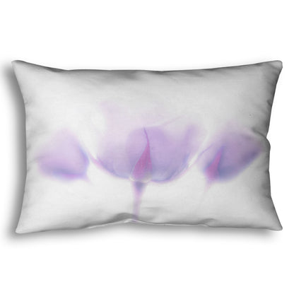 A throw pillow designed with a  photo of three pale purple roses against a pure white background, enveloped in a gentle white glow.