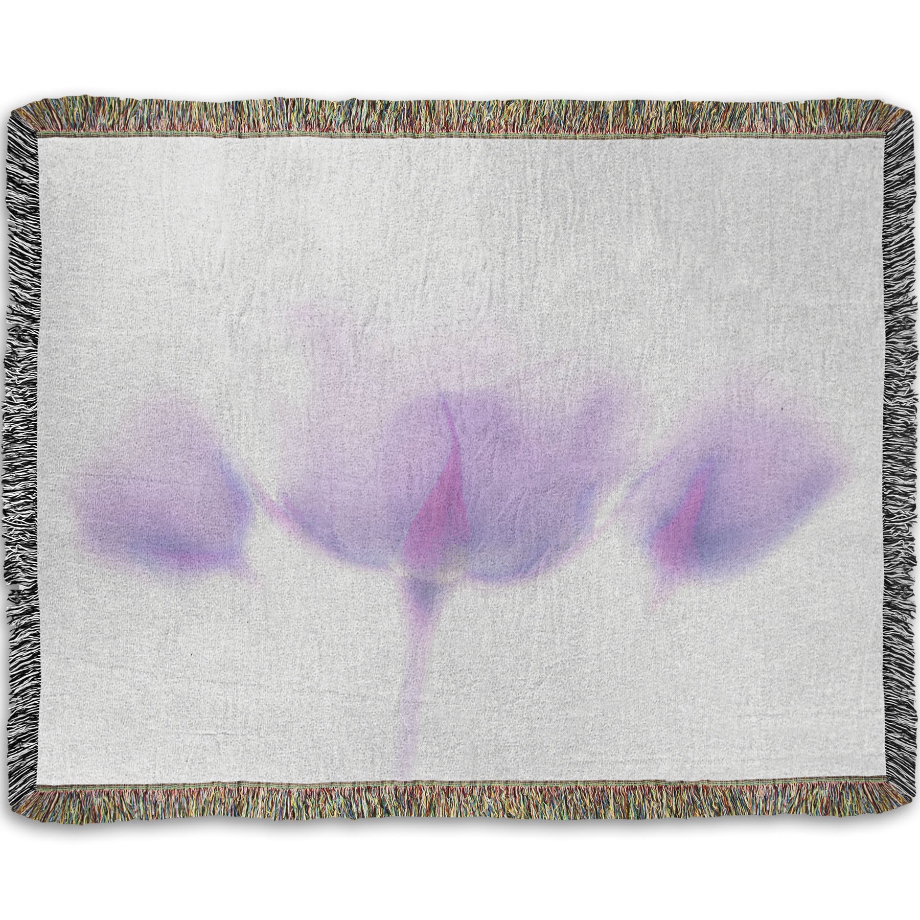 A woven throw blanket designed with a  photo of three pale purple roses against a pure white background, enveloped in a gentle white glow.