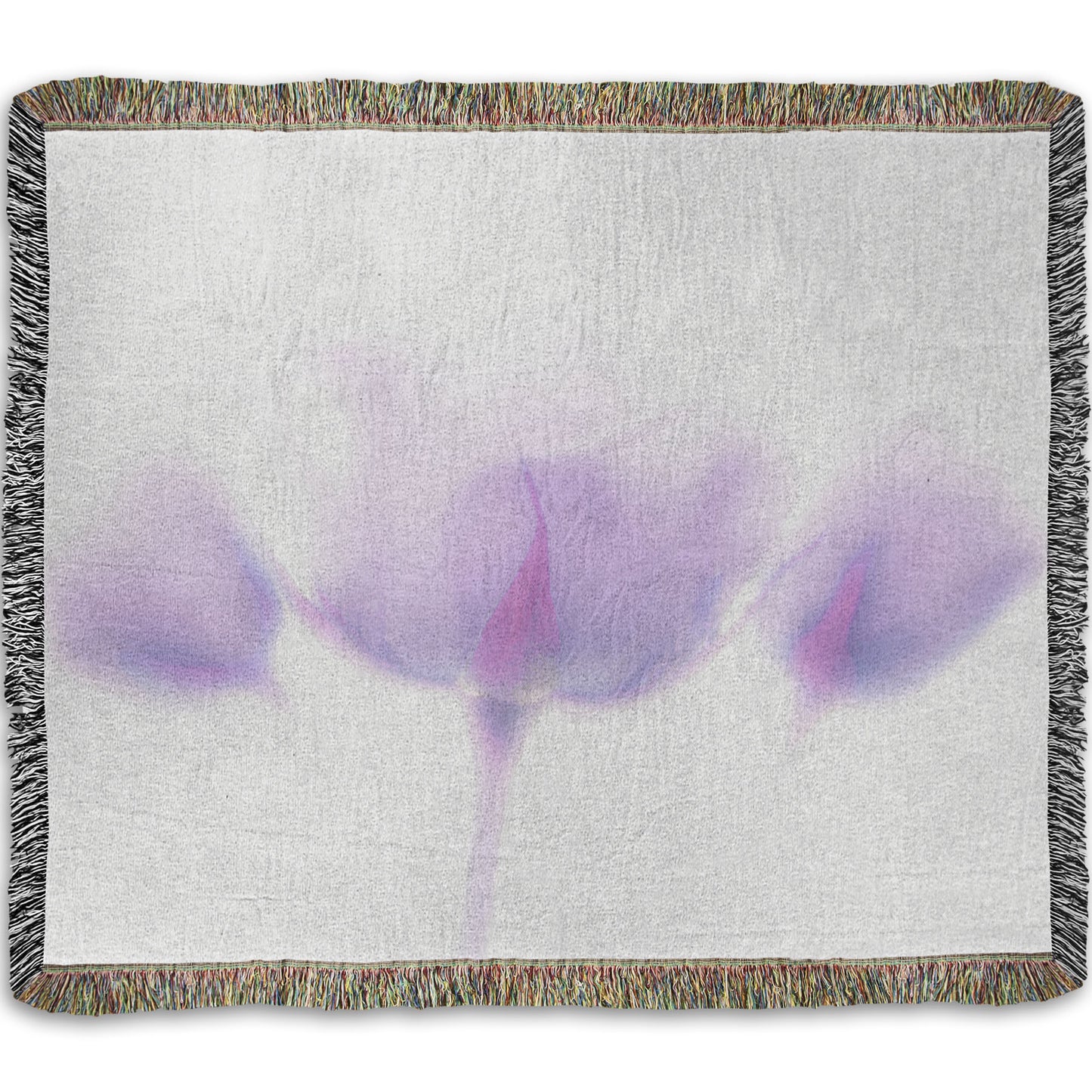 A woven throw blanket designed with a  photo of three pale purple roses against a pure white background, enveloped in a gentle white glow.
