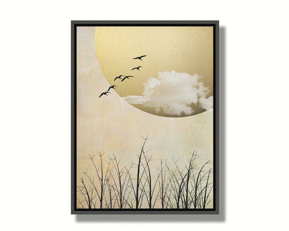 A photo collage art piece of migratory birds flying south for the winter, silhouetted against a big gold moon. Printed on canvas in a float frame.