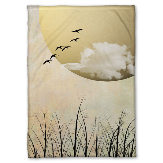 Fleece throw blanket designed with a photo collage of migratory birds flying south for the winter, silhouetted against a big gold moon. 
