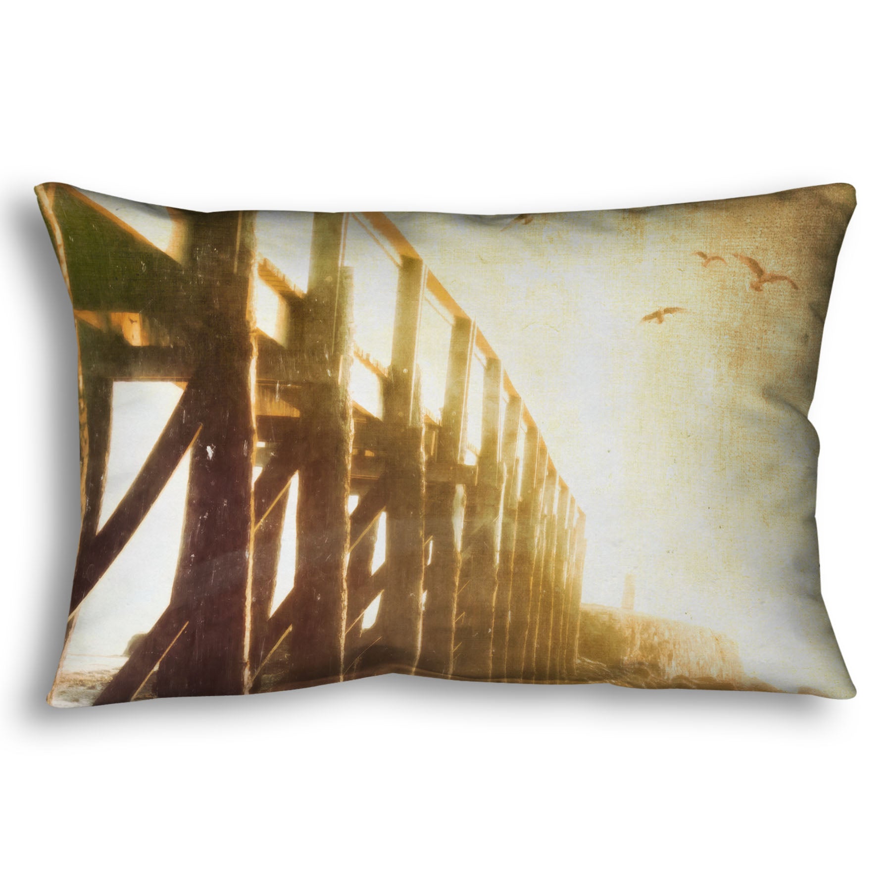 A throw pillow designed with a sepia photo looking out to sea along the side of a pier, as seagulls fly above. 