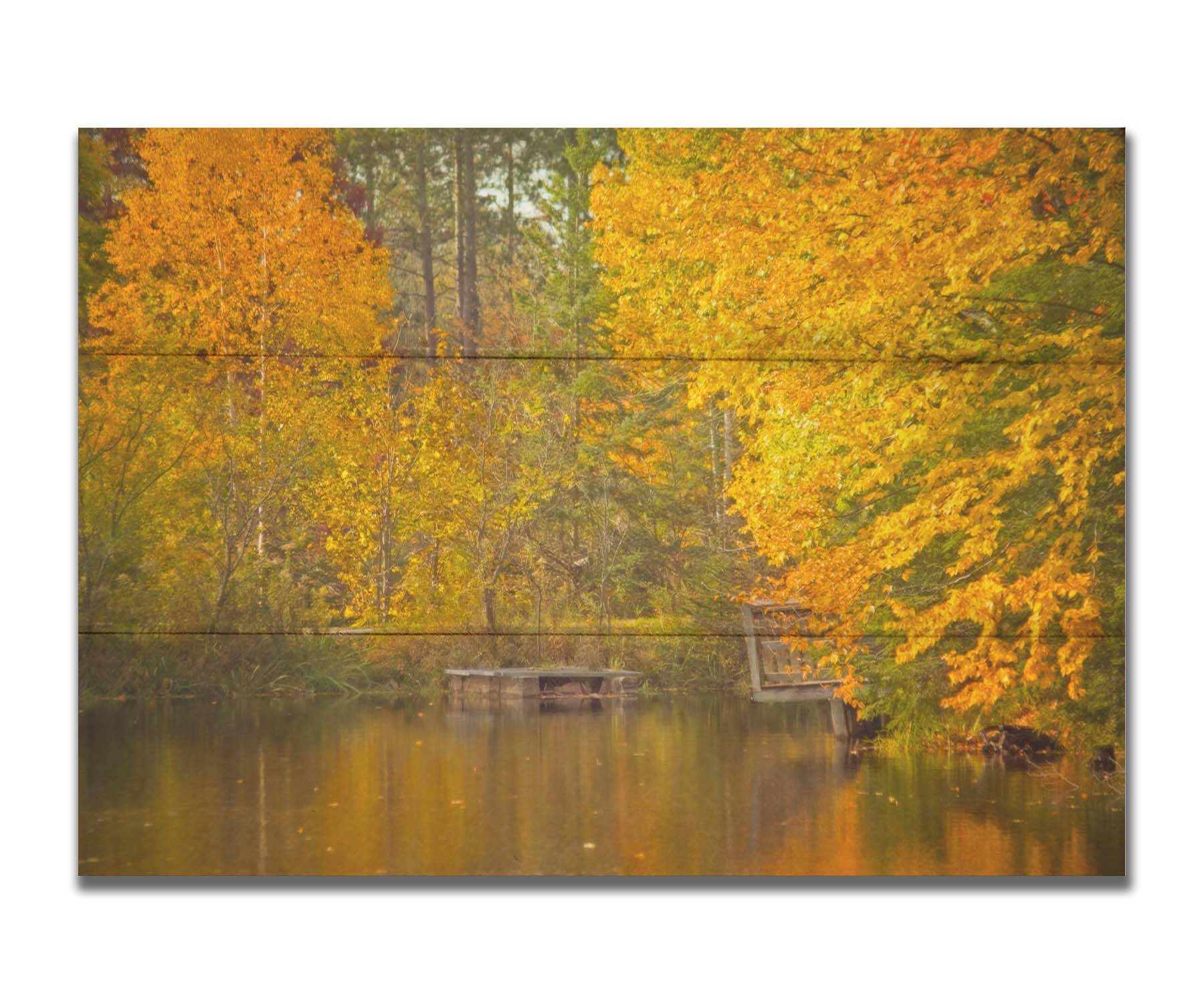 A photo of yellow autumn trees at a pond, their leaves reflecting off the water. Printed on a box board.