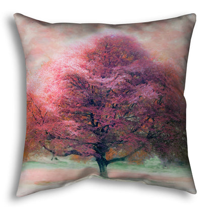 A throw pillow designed with an edited photo of a beech tree, its leaves pink for autumn. It has been modified to have a painterly look.