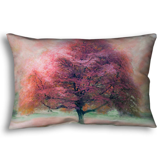 A throw pillow designed with an edited photo of a beech tree, its leaves pink for autumn. It has been modified to have a painterly look.