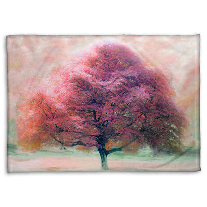 A fleece throw blanket designed with an edited photo of a beech tree, its leaves pink for autumn. It has been modified to have a painterly look.