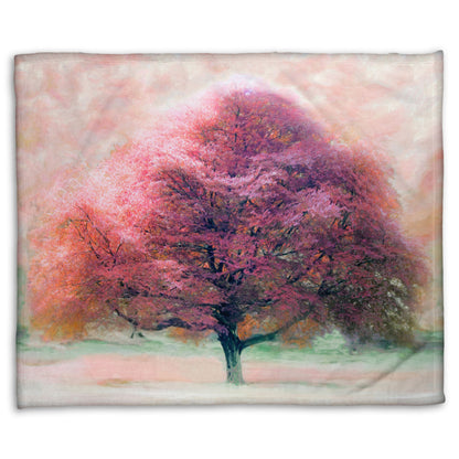 A fleece throw blanket designed with an edited photo of a beech tree, its leaves pink for autumn. It has been modified to have a painterly look.