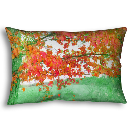 A throw pillow designed with a photo of a tree's red leaves. The rest of the image has been edited green.