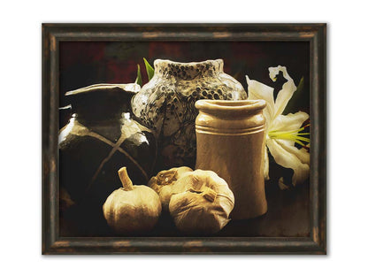 A photo of a still life arrangement of pottery and plants with a dark, warm palette. Printed on canvas and framed.