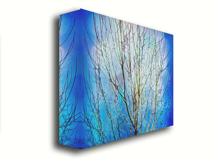 A photo looking up at a leafless tree against a bright blue sky, edited to have a painterly quality. Printed on canvas.