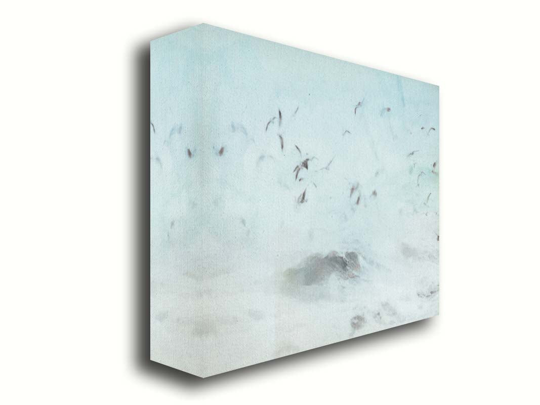 A photo edit of birds flying low over the stormy ocean, searching for a meal. Printed on canvas.