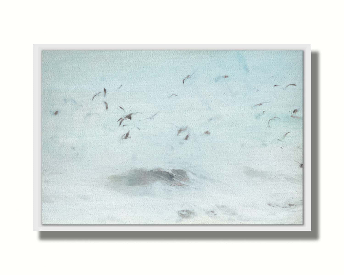 A photo edit of birds flying low over the stormy ocean, searching for a meal. Printed on canvas in a float frame.