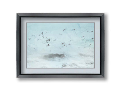 A photo edit of birds flying low over the stormy ocean, searching for a meal. Printed on paper, matted, and framed.