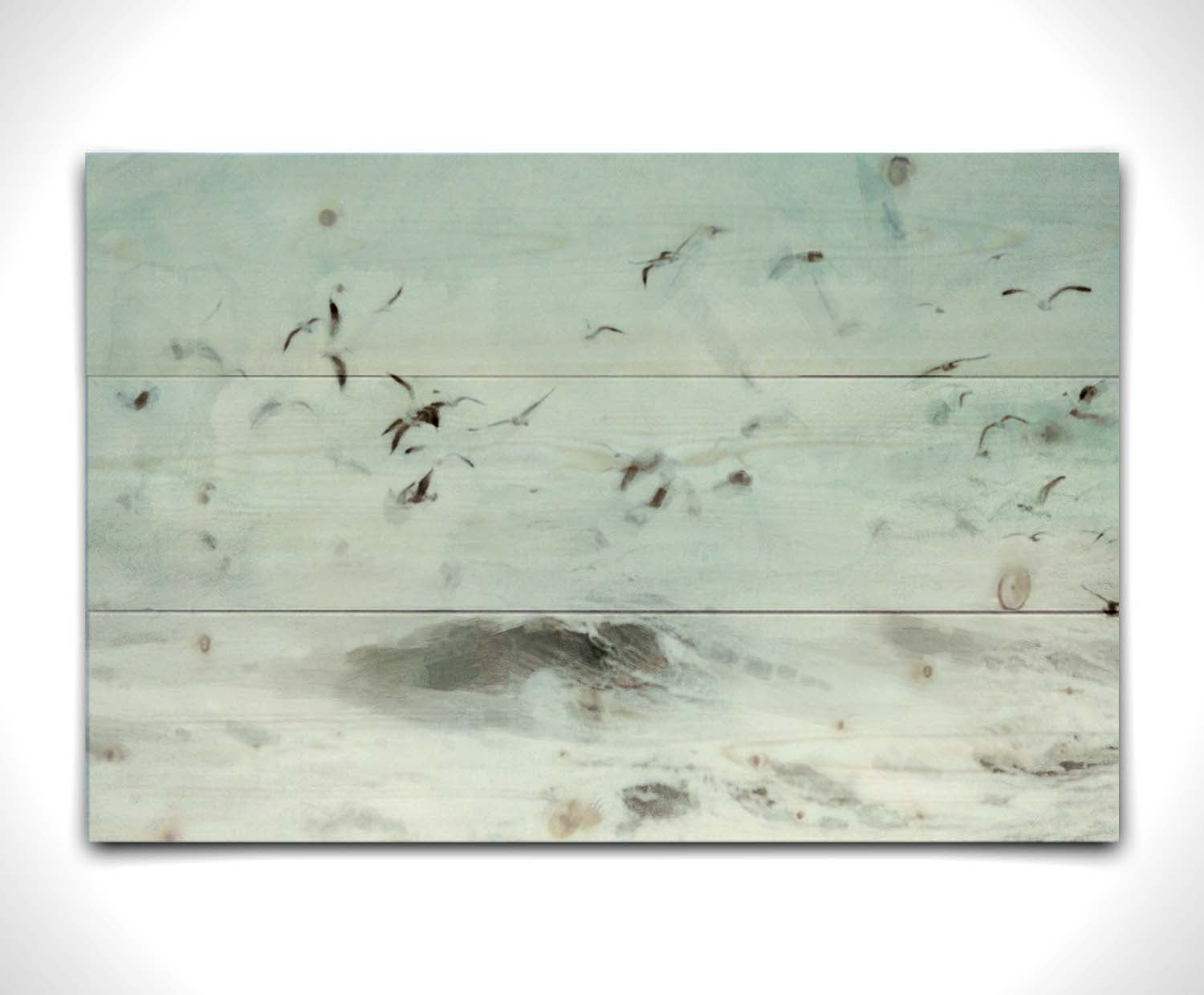 A photo edit of birds flying low over the stormy ocean, searching for a meal. Printed on a wood pallet.