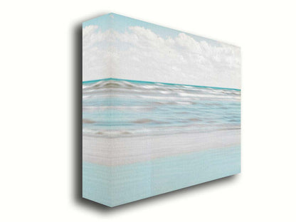 A photo of the ocean, and the line formed at the horizon where its color cuts across the sky of fluffy, white clouds. Printed on canvas.