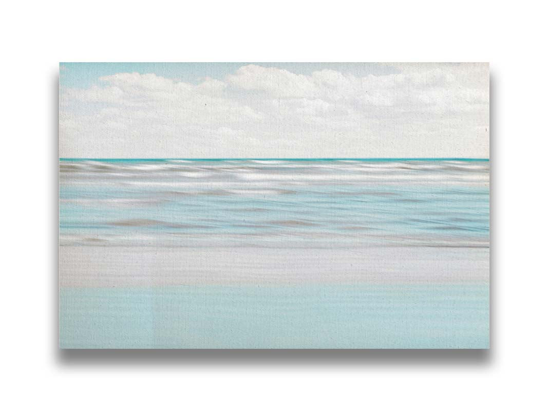 A photo of the ocean, and the line formed at the horizon where its color cuts across the sky of fluffy, white clouds. Printed on canvas.