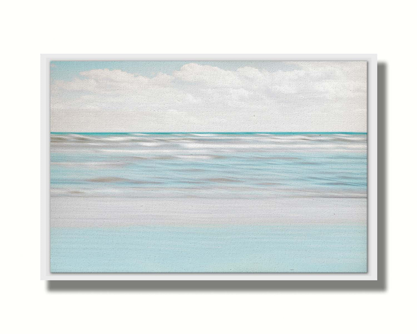 A photo of the ocean, and the line formed at the horizon where its color cuts across the sky of fluffy, white clouds. Printed on canvas in a float frame.