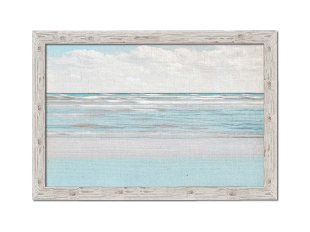 A photo of the ocean, and the line formed at the horizon where its color cuts across the sky of fluffy, white clouds. Printed on canvas and framed.