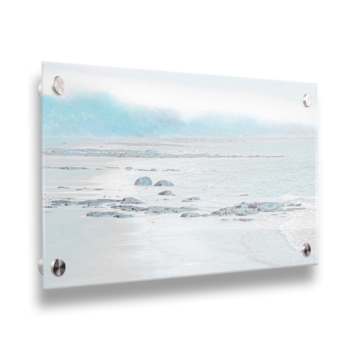 A photo of a rocky beach with a pale blue palette. The sea is calm and washing over the sand and rocks. Printed on acrylic.