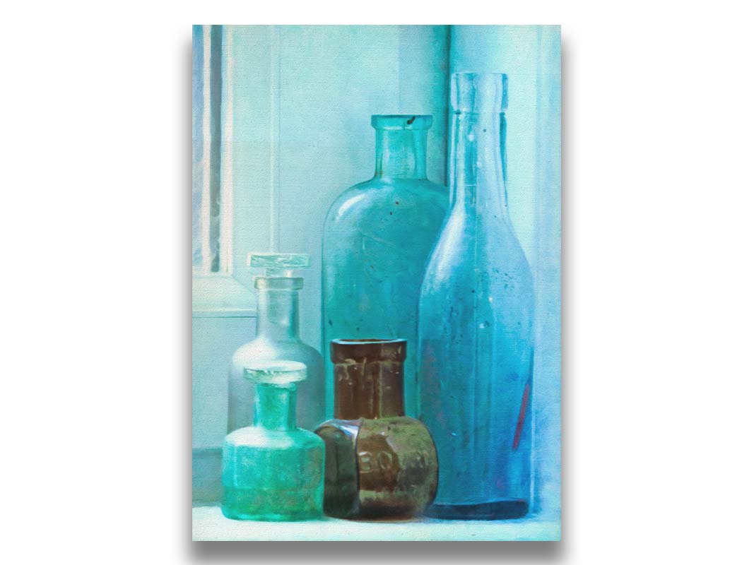 A photo of an assortment of blue and brown bottles, sitting in the corner on a window stool. Printed on canvas.