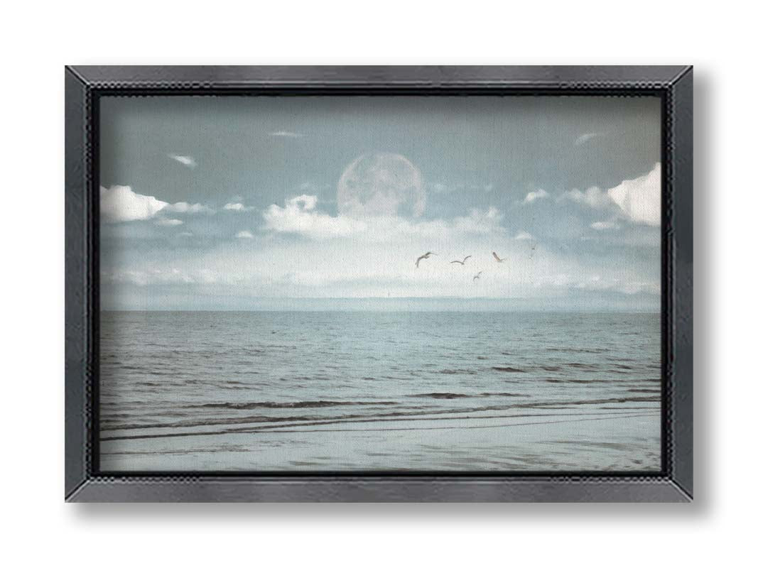 A photo of a pale blue sea with a lage moon on the horizon. Printed on canvas and framed.