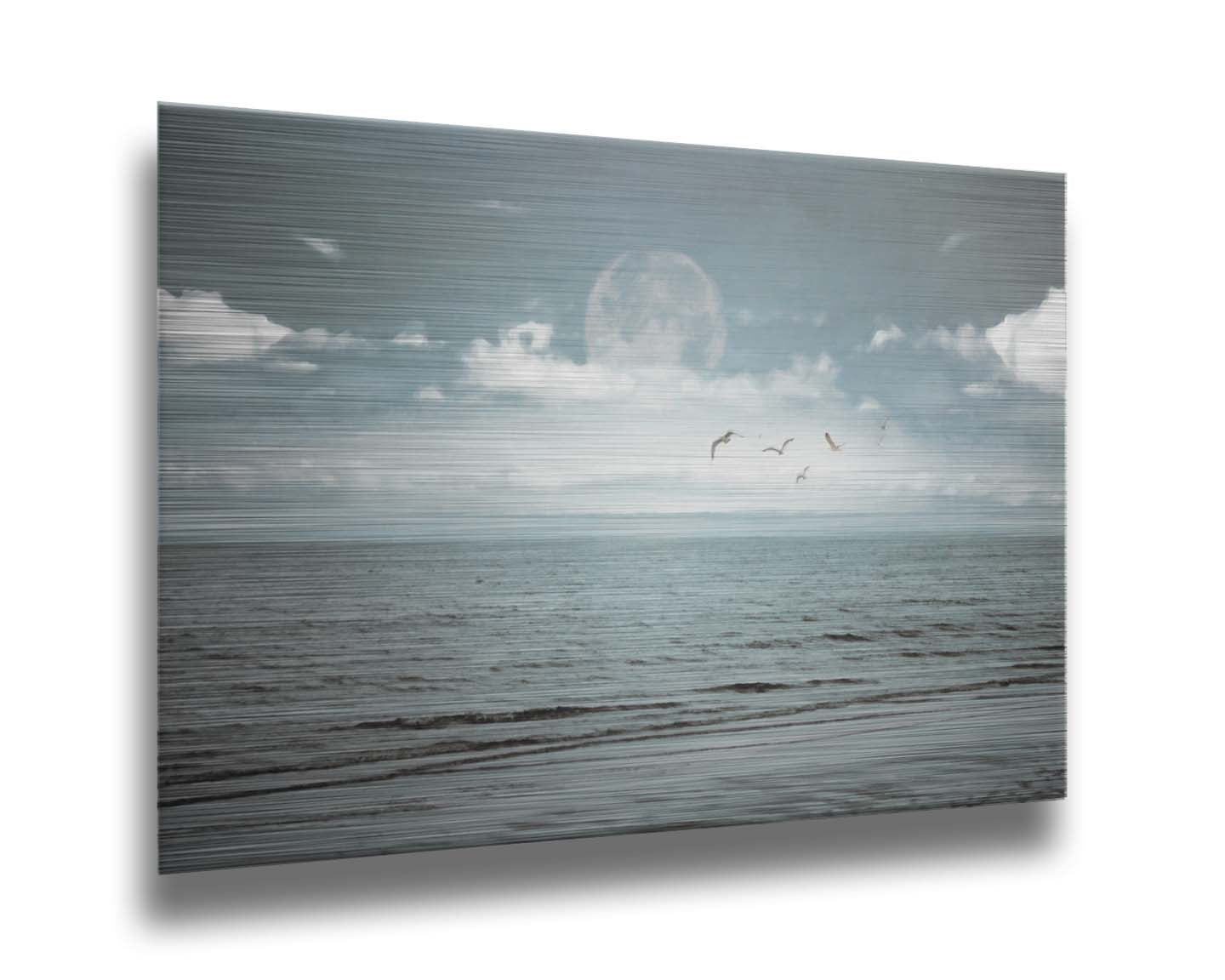 A photo of a pale blue sea with a lage moon on the horizon. Printed on metal.