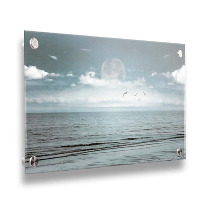 A photo of a pale blue sea with a lage moon on the horizon. Printed on acrylic.