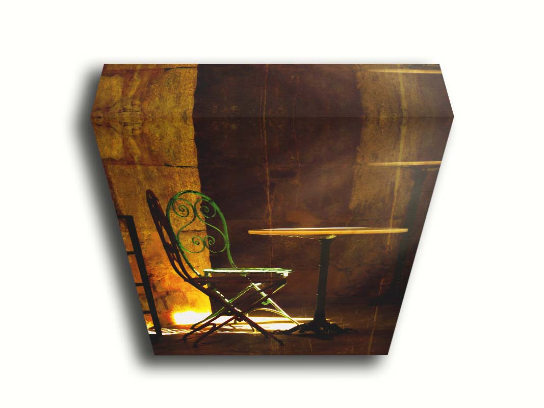 A photo of chairs around a small table, illuminated by light pouring in through the window. Printed on canvas.