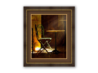 A photo of chairs around a small table, illuminated by light pouring in through the window. Printed on paper, matted, and framed.