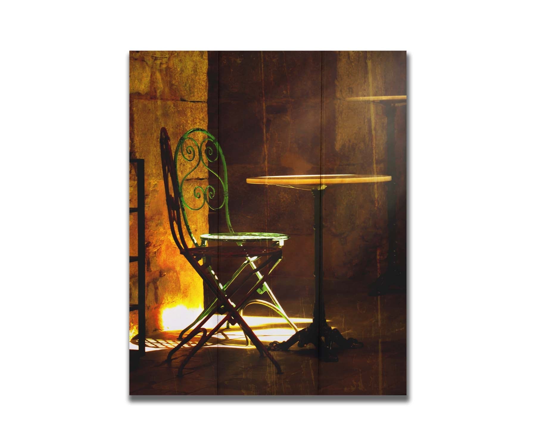 A photo of chairs around a small table, illuminated by light pouring in through the window. Printed on a box board.