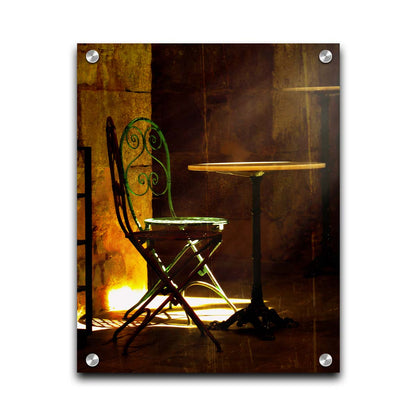 A photo of chairs around a small table, illuminated by light pouring in through the window. Printed on acrylic.