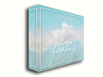 A photo of tall grass under a blue sky with white clouds. The phrase "Life is short, choose happiness" is superimposed on the image. Printed on canvas.