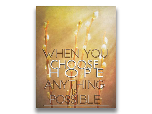 A photo of four stems of plant buds bathed in golden light. The phrase "When you choose hope, anything is possible" is superimposed on the center. Printed on canvas.