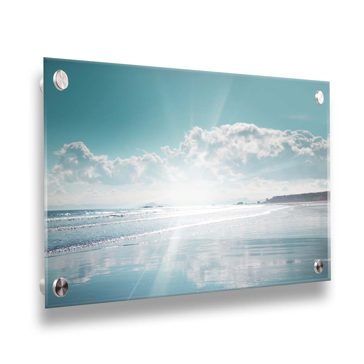 A photo of an ocean view, with a town on the coast. The sun is getting low in the sky, just before sunset, and the light is reflecting off the blue water and wet sand. Printed on acrylic.