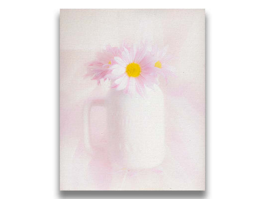 A photo of a white vase with pink daisies in a soft pink background. Printed on canvas.