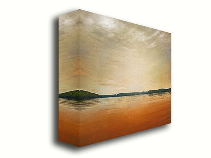 A photograph looking out at the sea and sky. The sky is cloudy and a warm gray, while the sea reflects a brilliant orange. Coastlines of trees can be seen in the distance. Printed on canvas.