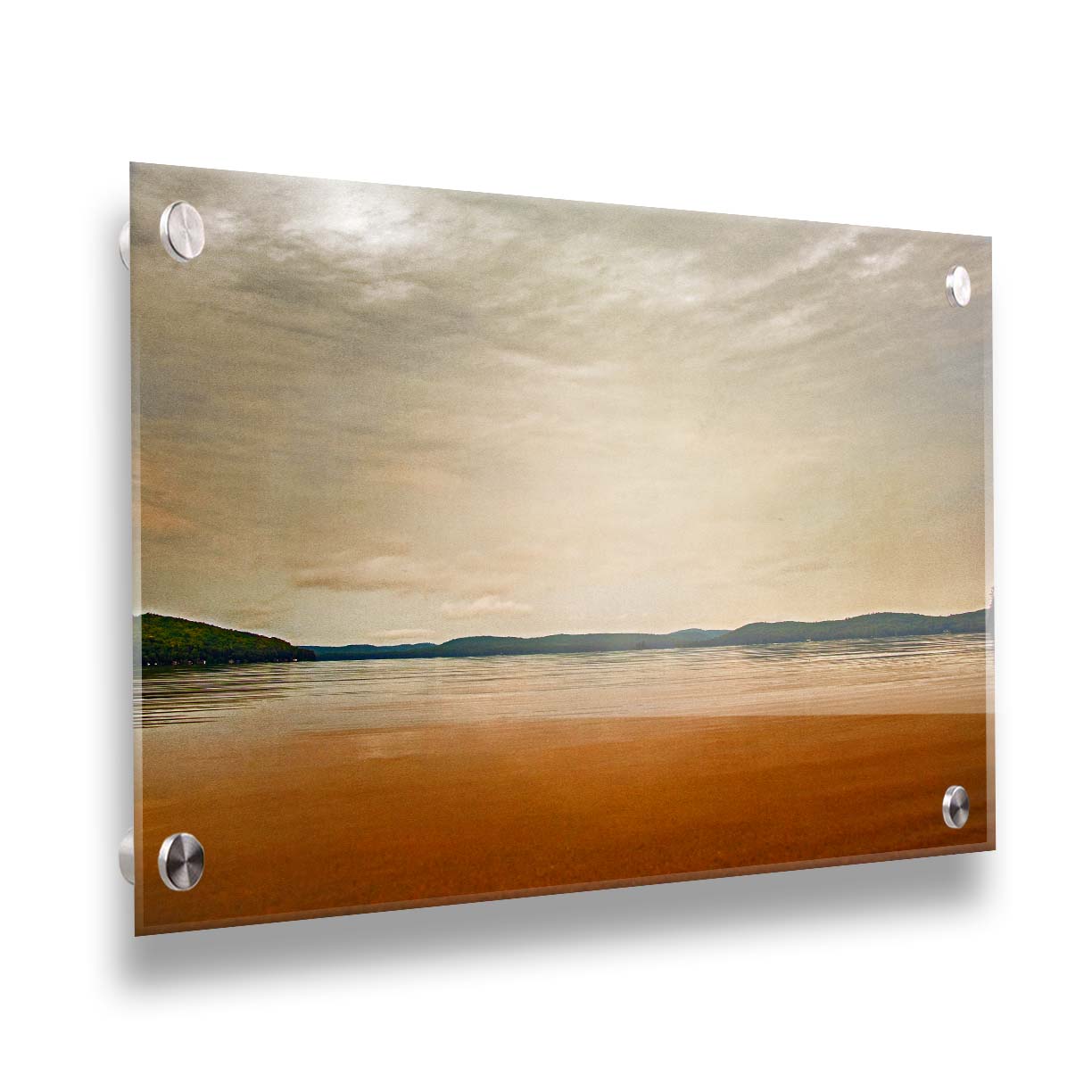 A photograph looking out at the sea and sky. The sky is cloudy and a warm gray, while the sea reflects a brilliant orange. Coastlines of trees can be seen in the distance. Printed on acrylic.