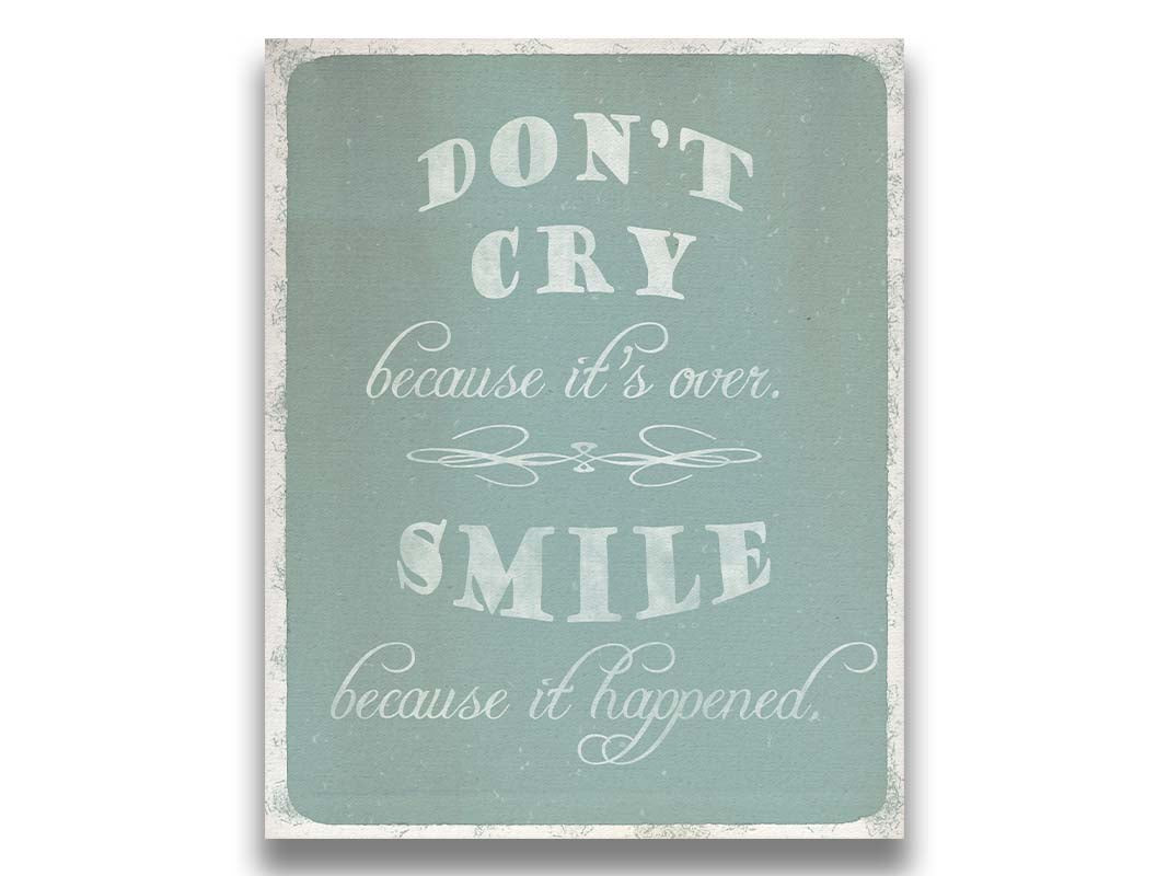 A typography design reading "Don't cry because it's over, smile because it happened" in white on a blue background. Printed on canvas.