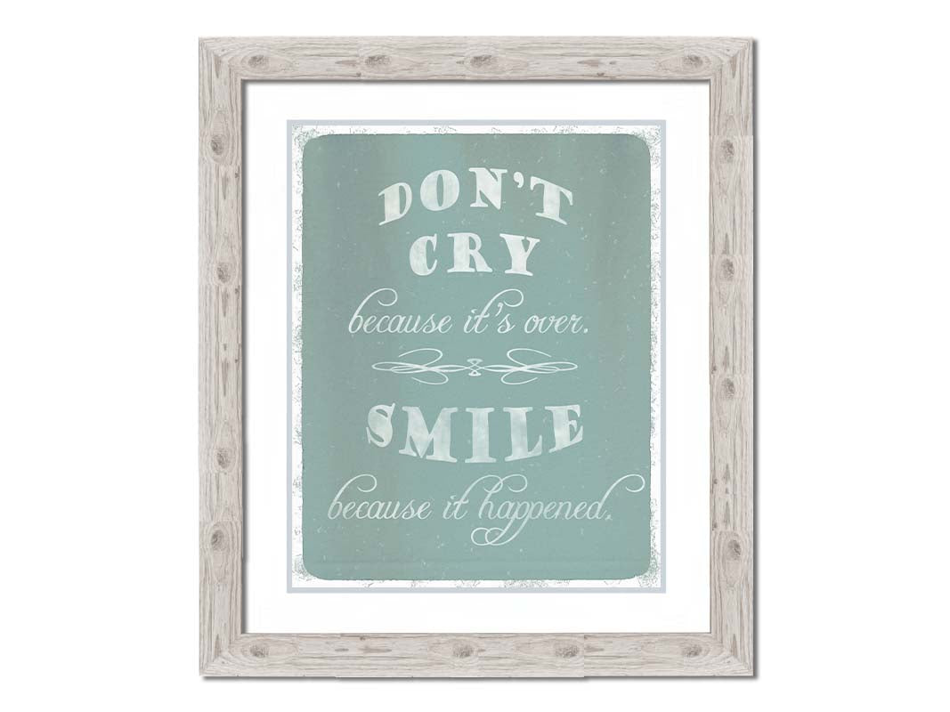 A typography design reading "Don't cry because it's over, smile because it happened" in white on a blue background. Printed on paper, matted, and framed.