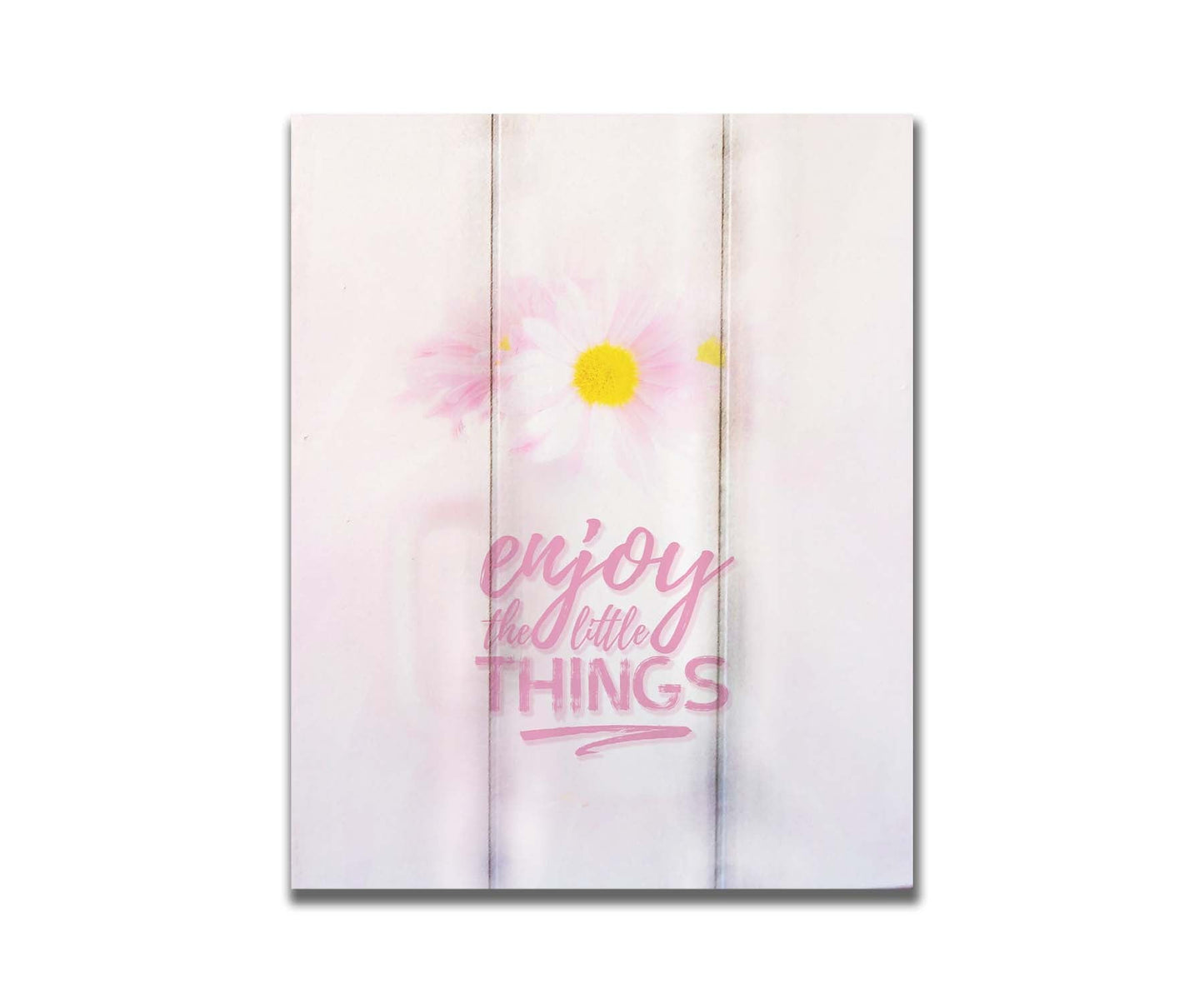 A photo of a white vase with pink daisies in a soft pink background, superimposed with the phrase "enjoy the little things". Printed on a box board.