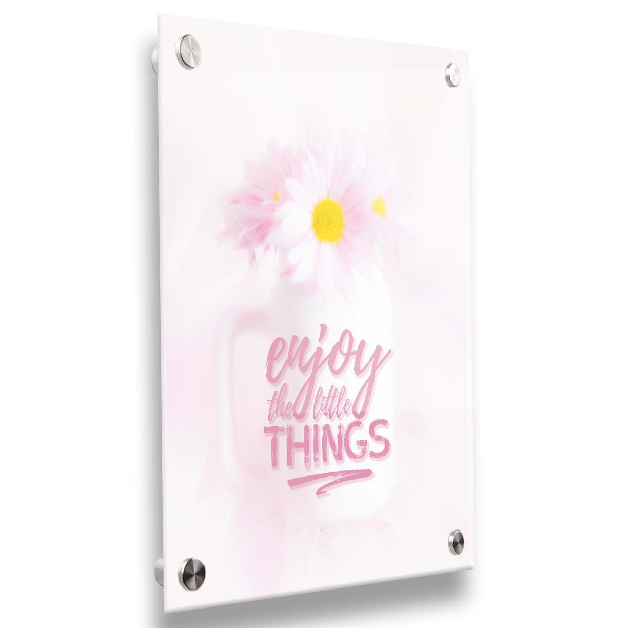 A photo of a white vase with pink daisies in a soft pink background, superimposed with the phrase "enjoy the little things". Printed on acrylic.